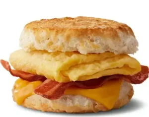 McDonald's Bacon, Egg, and Cheese Biscuit with crispy bacon, scrambled eggs, and melted cheese in a flaky biscuit.