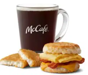 McDonald's Bacon, Egg & Cheese Biscuit Meal with crispy hash brown and a cup of hot coffee.