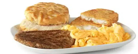 McDonald's Big Breakfast with scrambled eggs, sausage patty, golden hash browns, and a warm biscuit