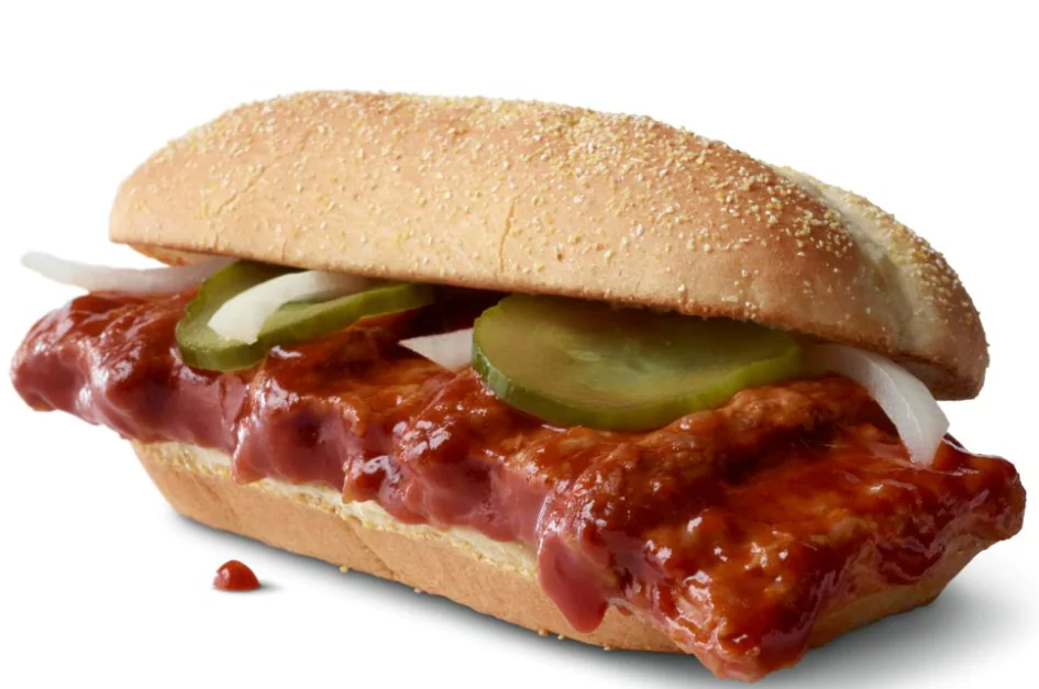 McRib® sandwich with tender pork, tangy barbecue sauce, pickles, and onions on a toasted bun.